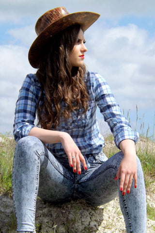 Cowgirl wearing a flannel shirt and jeans