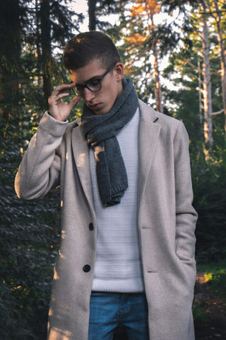Young man wearing a scarf with a coat