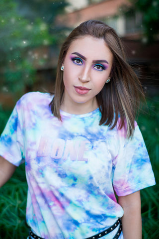 Close photo of a young woman wearing a tie-dyed t-shirt