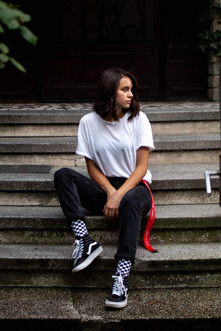 black vans outfit with black jeans and a basic white tee
