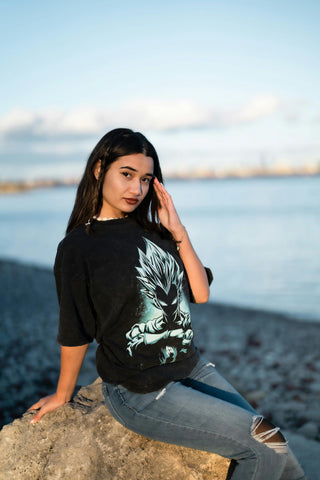 Girl posing with a graphic tee and ripped jeans