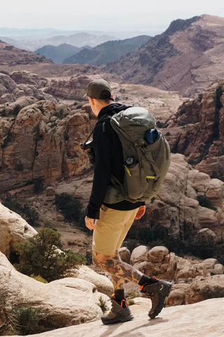 Man wearing bermuda shorts and long socks and trekking shoes