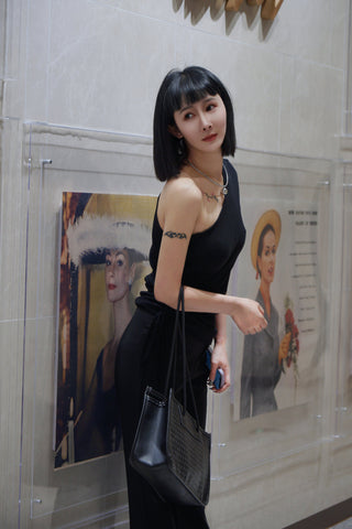 Asian woman posing with a black dress