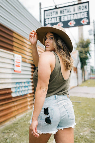 Pompeii outfits girl wearing denim shorts and a tank top