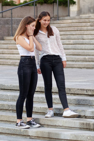 Two girls in jeans and white shirts outfits