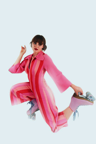 Woman posing with lollipop-colored jumpsuit and roller skates