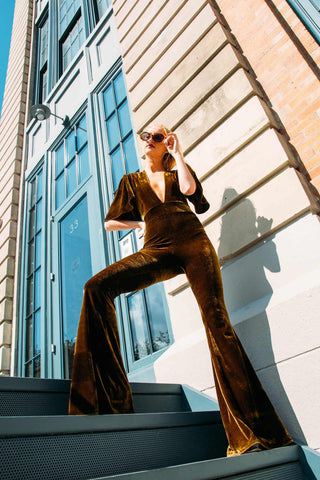 Woman posing with a velvet flared jumpsuit