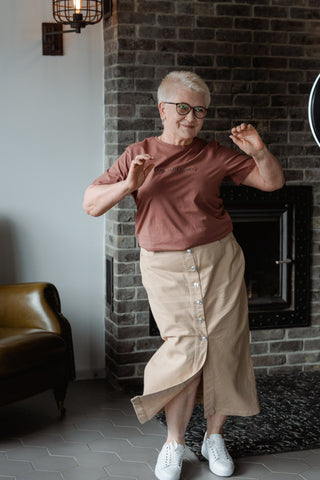 Elderly woman dancing in casual outfit of a straight skirt and a basic t-shirt