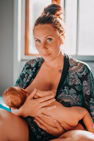 Woman breastfeeding and wearing a patterned kimono robe