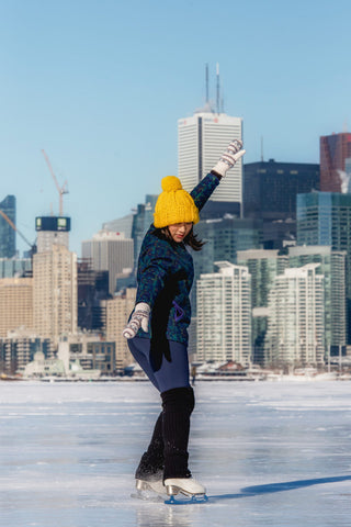 Girl on the ice ring wearing leggings and leg warmers