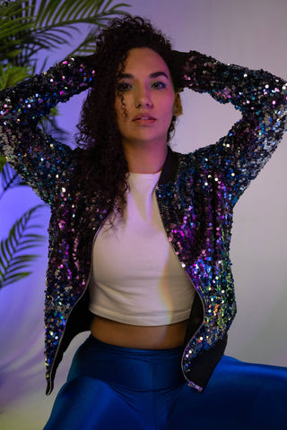 Close photo of a woman wearing leggings and a sequin jacket