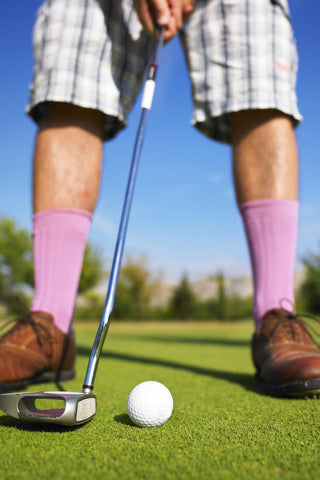 close shot of a man putting wearing long socks