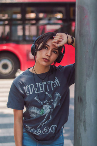 Girl wearing a led zeppelin t-shirt and headphones