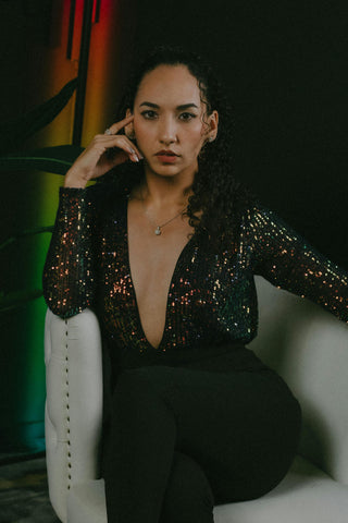 Close photo of a woman posing with a sequin top