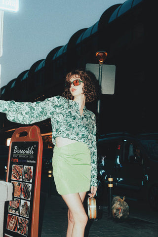Vintage photo of a woman with a floral shirt and a mini skirt
