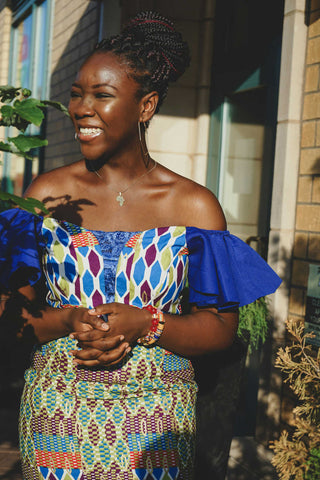 Smiling black woman wearing colorful ruffled top