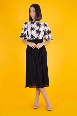 Woman wearing a black midi skirt with an elegant blouse