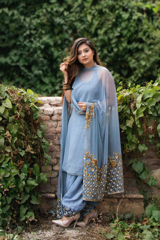 Woman posing in light blue chikancari kurta and stiletto heels