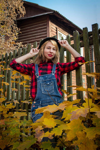 Young woman posing with a flannel shirt and rompers