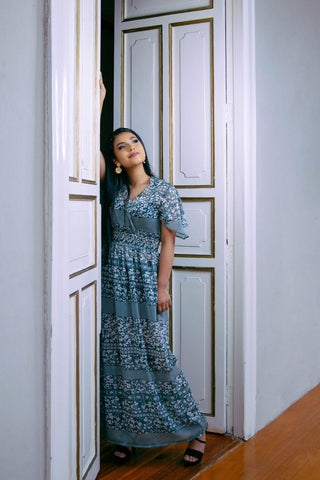 woman posing with a floral maxi dress