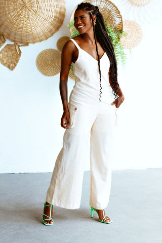 Black woman wearing a white summer jumpsuit