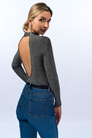 Back photo of a girl wearing a backless fitted top with jeans
