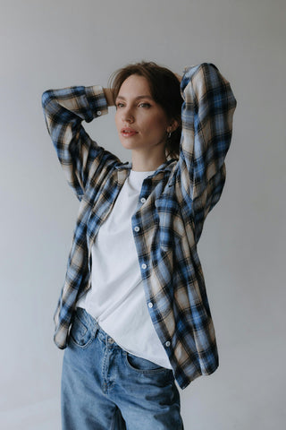 Woman posing with a flannel shirt over a white tee