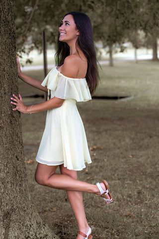 Woman posing with a white mini summer dress