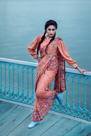 Woman posing in traditional Indian clothes and light blue sneakers