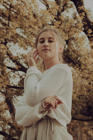 Close photo of a young girl wearing a sweater