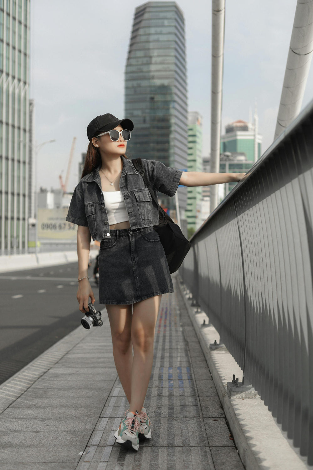 Asian girl posing with a total denim outfit with a jacket and a skirt