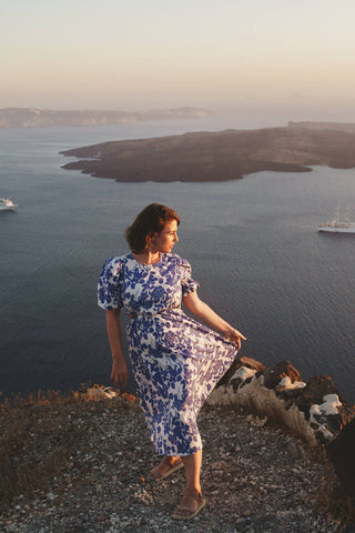 Woman on the cliffs wearing a floral maxi dress