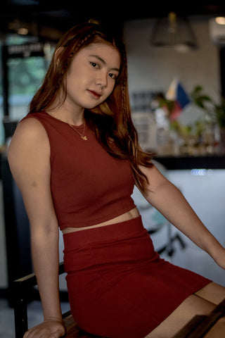 Girl posing in a bar wearing a brown monochrome outfit