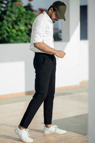 Man dressed with a white shirt and black chino pants