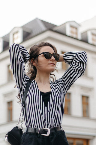 close shot of a girl wearing a tank top with a shirt on top