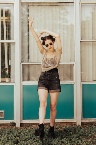 Girl wearing a transparent top and denim shorts