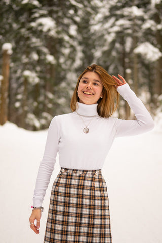 Girl wearing white turtleneck sweater