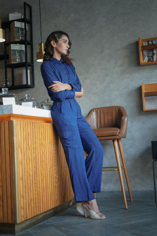 Woman in a bar wearing a monochrome blue jumpsuit