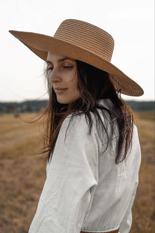 A woman in a wide brimmed straw hat