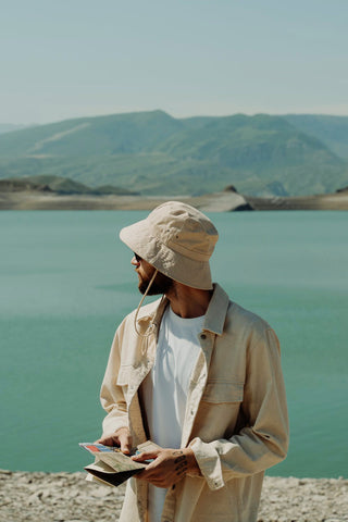 Man holding a map and looking over the river