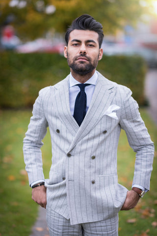 Man posing with a pinstripe suit