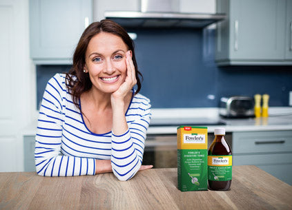 Woman with Digestive Tonic on counter