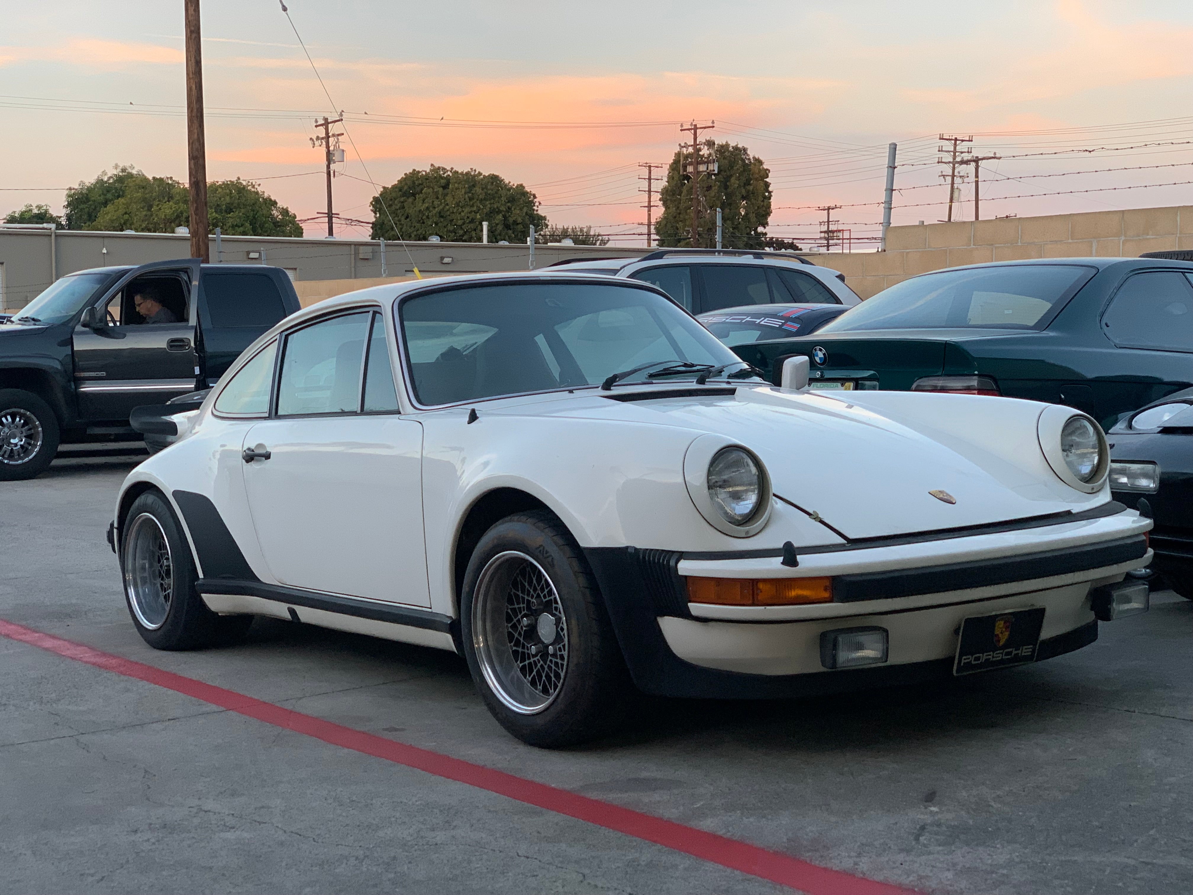 A 1976 Porsche 911 Turbo Carrera Front Quarter View sitting in the parking space of the shop.