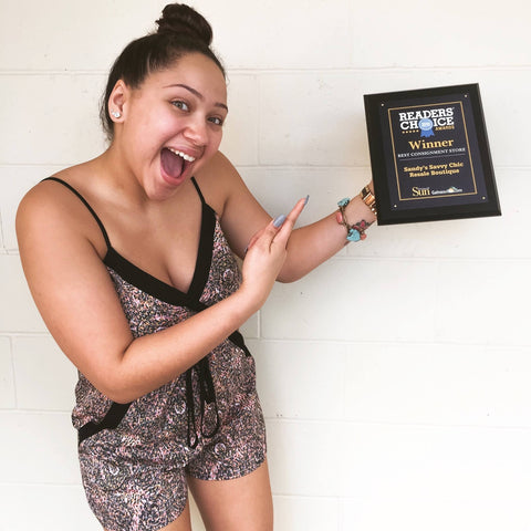 fashionable employee pointing at award plaque