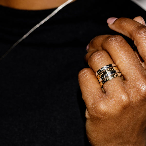 Woman wearing four customizable engraved rings