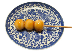 A skewer of Mitarashi Dango made with Organic raw honey from Hawaiian Rainbow Bees Hawaii Honey, Lehua Blossom honey