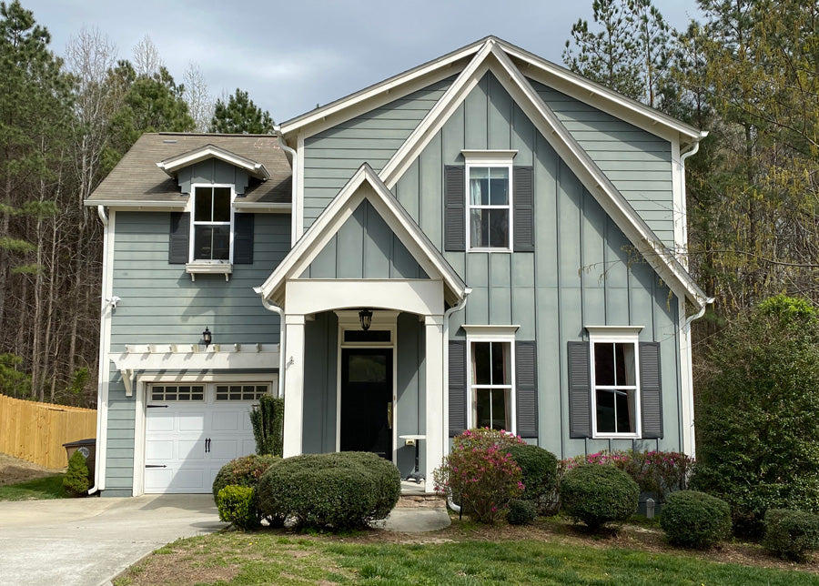 This cottage-style family home was originally painted a dark gray that has faded over time in the harsh sunlight. This before picture shows the original colors.