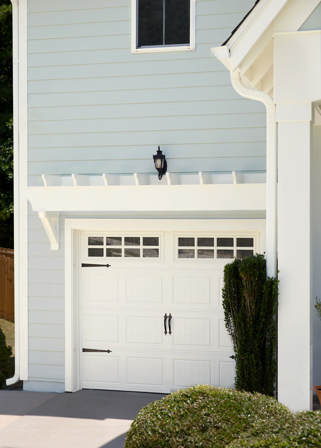 To complement the gray exterior paint on the siding, the homeowner chose Timeless from Clare paint for the trim around the garage and the garage door. 