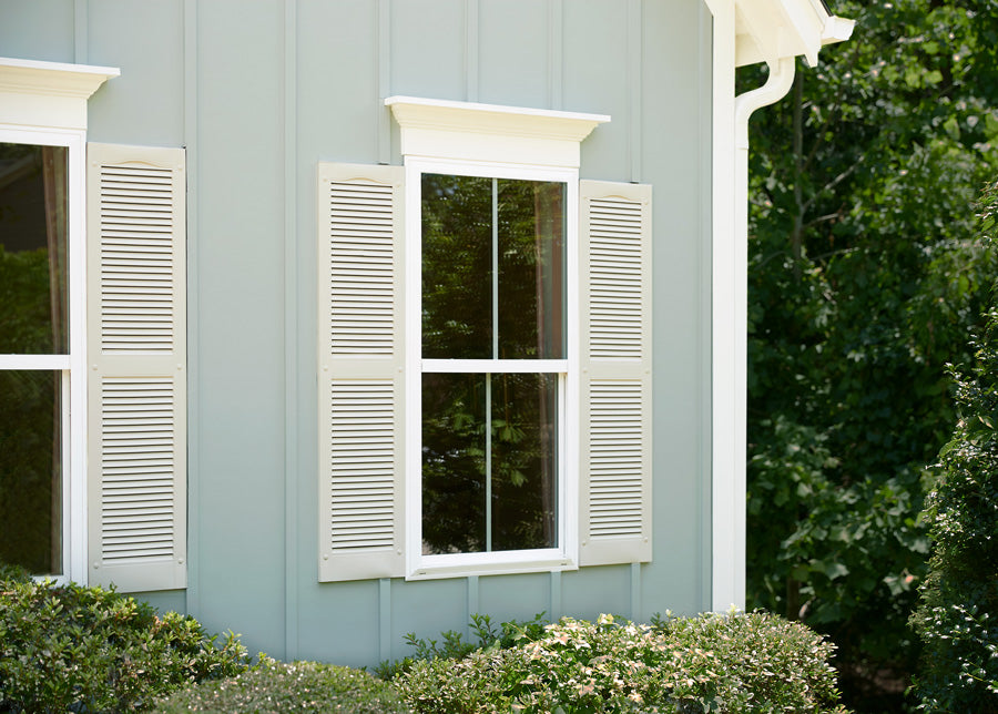 The shutters are painted with Clare’s No Filter, a light beige that works well with gray exterior paint and other exterior paint colors chosen by the homeowner.