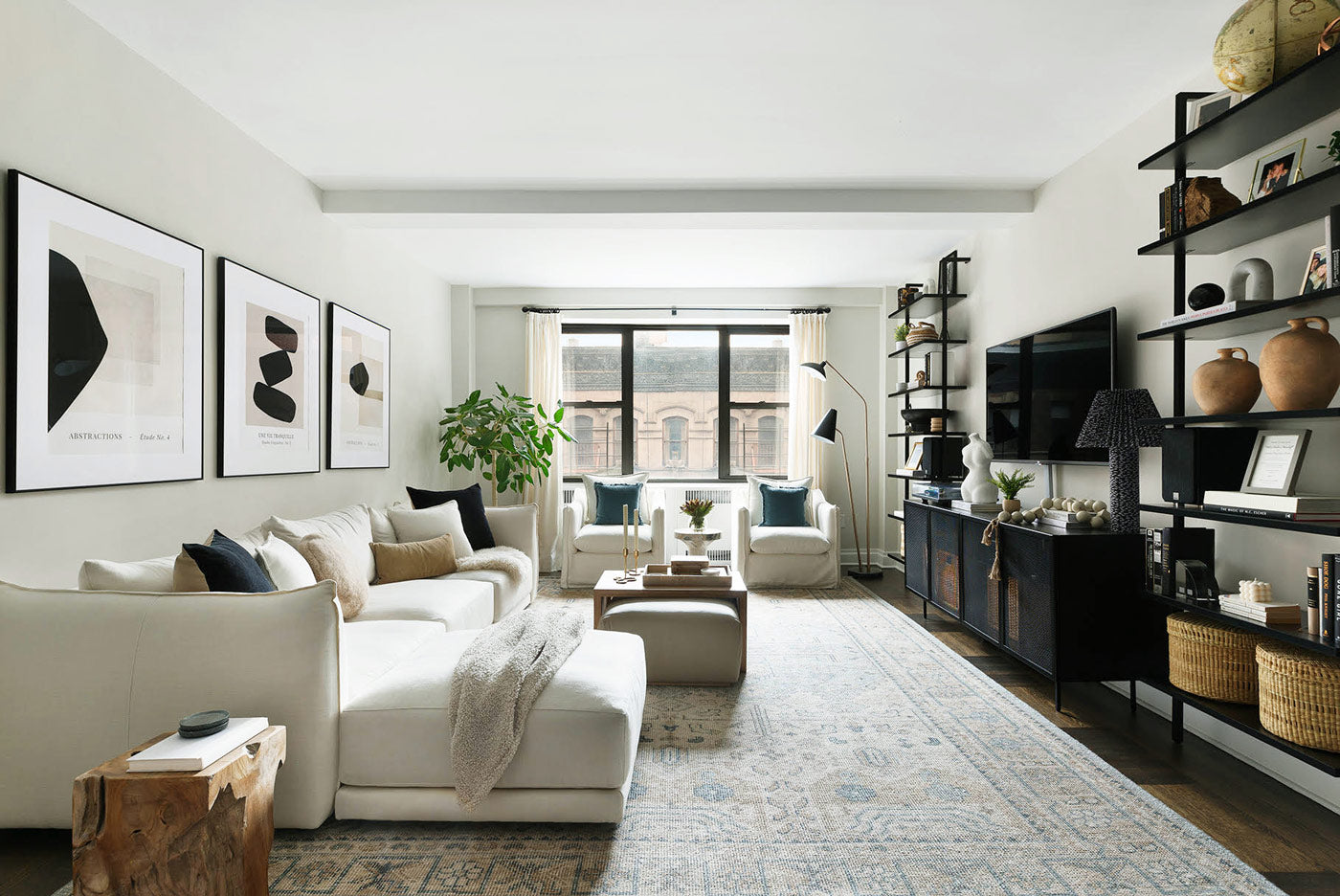 The living room of this New York City apartment is painted in Classic—Clare’s lightest beige paint. Designed by Alex Nino.